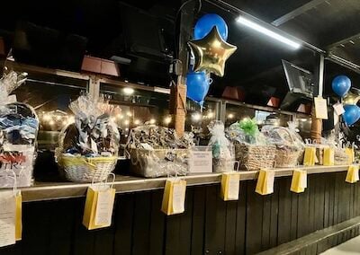 Gift Baskets in a line for raffling on a long counter